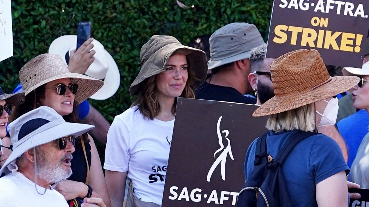 <i>Hollywood To You/Star Max/GC Images/Getty Images</i><br/>(From left) Katie Lowes and Mandy Moore walk the picket line in support of the SAG-AFTRA and WGA strike on in Los Angeles on July 18.