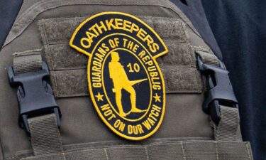 A member of the right-wing group Oath Keepers stands guard during a rally in front of the U.S. Supreme Court Building on January 5