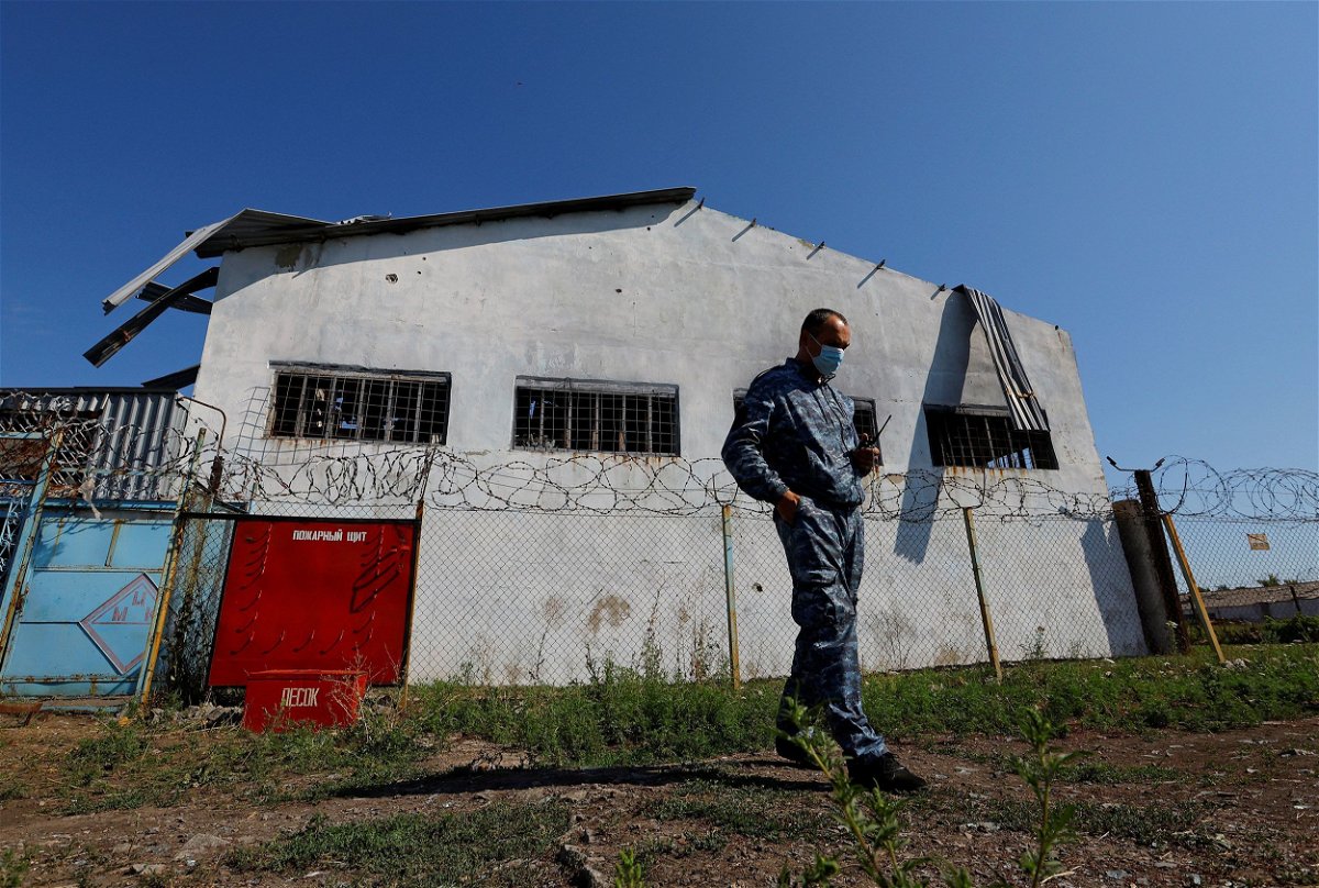 <i>Alexander Ermochenko/Reuters</i><br/>A security guard stands in front of the building in the settlement of Olenivka in the Donetsk Region