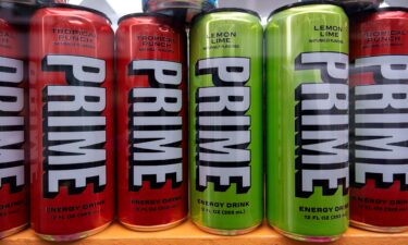 Various flavors of the energy drink PRIME for sale in a shop window in London.