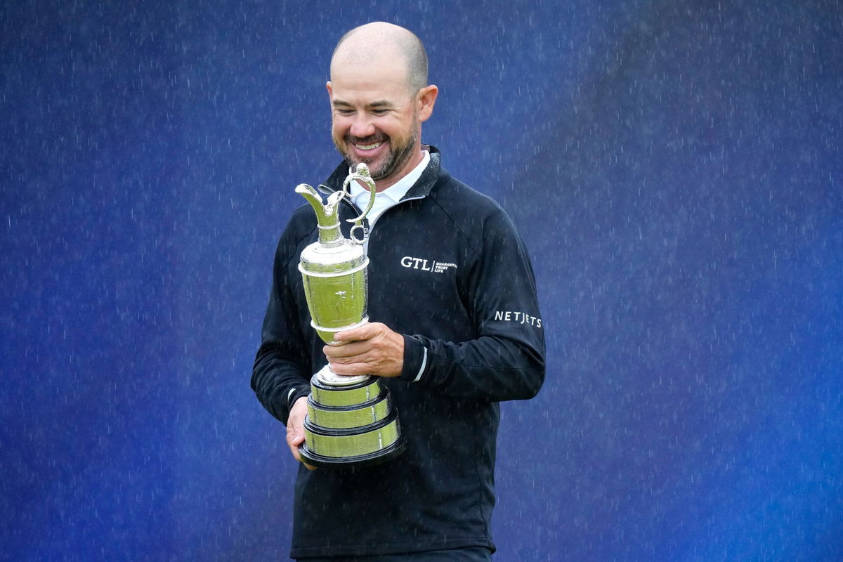 <i>Jon Super/AP</i><br/>Brian Harman poses with the Claret Jug.