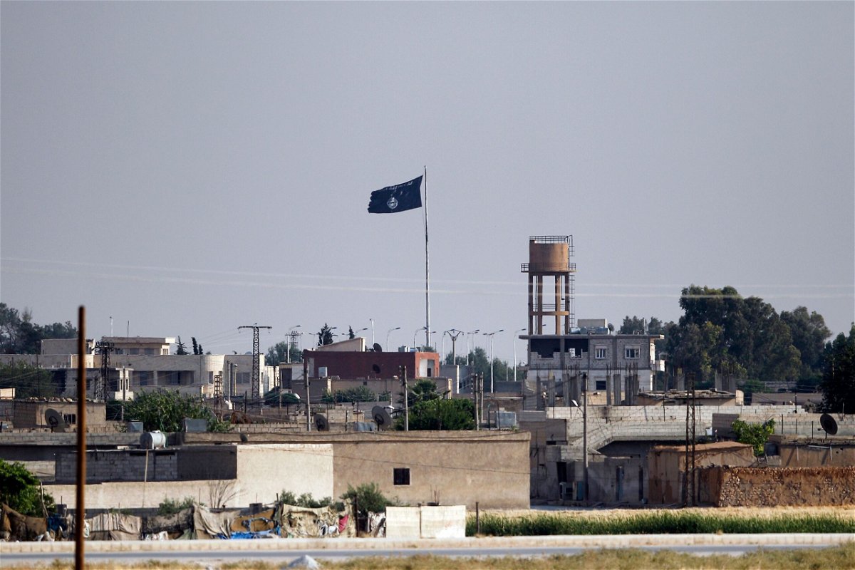 <i>Gokhan Sahin/Getty Images</i><br/>An ISIS flag flies in the northern Syrian town of Tel Abyad as seen from the Turkish border town of Akcakale on June 15