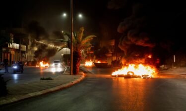 Tires are set on fire on a street during an Israeli military operation