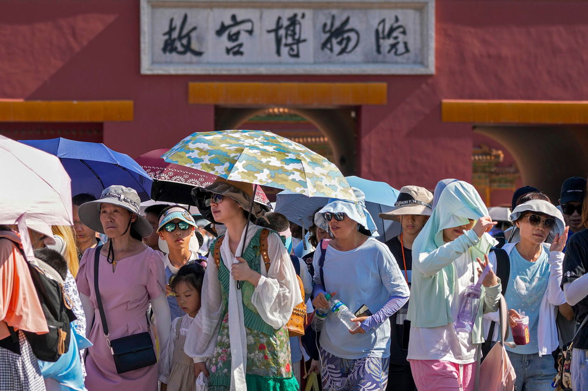 <i>Andy Wong/AP</i><br/>Visitors leaving the Forbidden City on a hot day in Beijing
