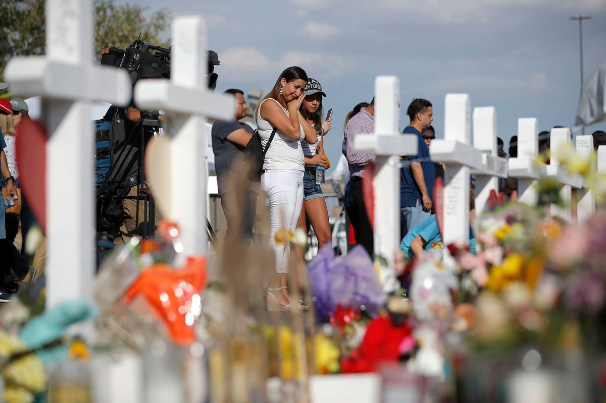 <i>John Locher/AP</i><br/>People visit a makeshift memorial at the site of the August 2019 shooting in El Paso