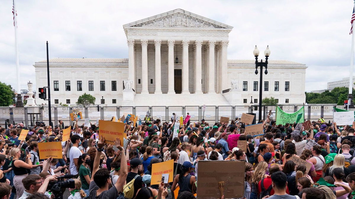 <i>Jacquelyn Martin/AP</i><br/>Protesters gather outside the Supreme Court in Washington on June 24