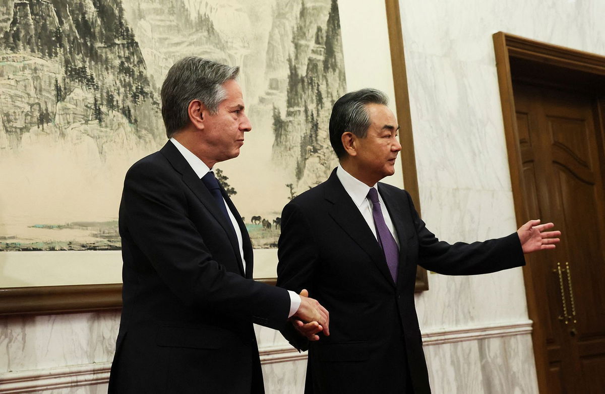 <i>Leah Millis/Reuters</i><br/>U.S. Secretary of State Antony Blinken shakes hands with China's Director of the Office of the Central Foreign Affairs Commission Wang Yi at the Diaoyutai State Guesthouse in Beijing