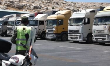 A convoy of trucks carrying humanitarian aid is seen parked after crossing the Syrian Bab al-Hawa border crossing with Turkey