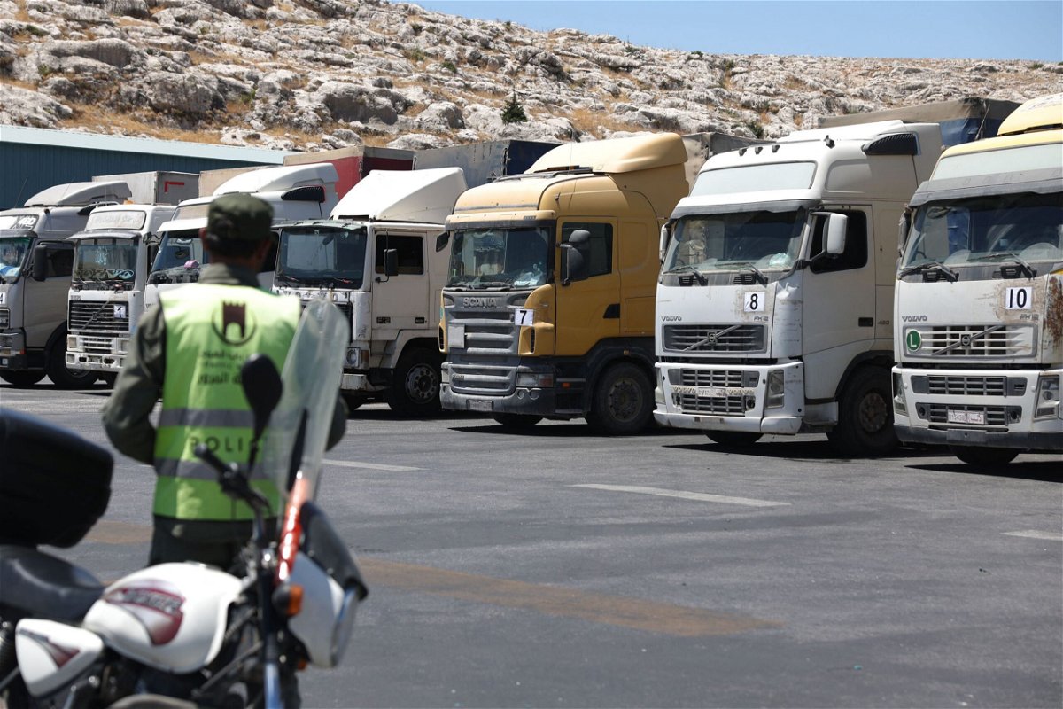 <i>Omar Haj Kadour/AFP/Getty Images</i><br/>A convoy of trucks carrying humanitarian aid is seen parked after crossing the Syrian Bab al-Hawa border crossing with Turkey