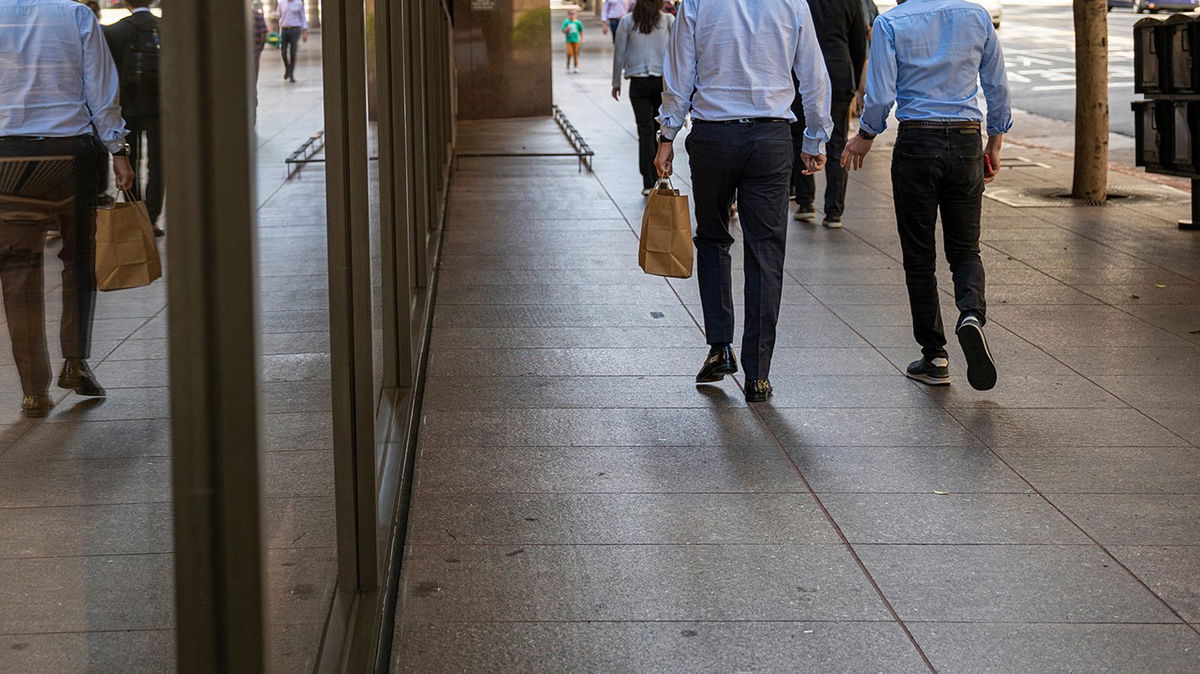 Pictured are pedestrians on California Street in the financial district of San Francisco, in 2022.