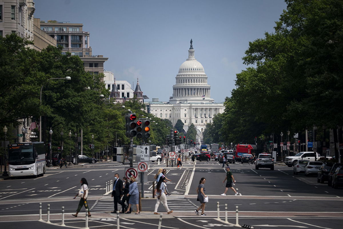 Pedestrians cross a street near the U.S. Capitol in Washington, D.C., on August 6, 2021.