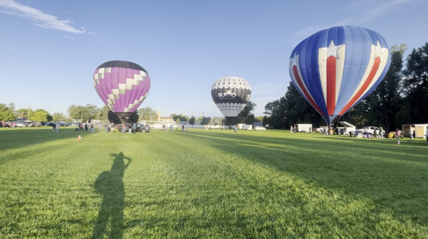 Multiple Hot air balloons blown up to show residents of Ammon