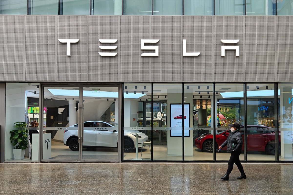 Pedestrians walk past a TESLA electric car store in Shanghai, China, on April 6.