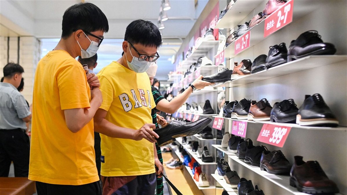 <i>Wang Zhao/AFP/Getty Images</i><br/>People select shoes in a shopping mall in Beijing on June 15.