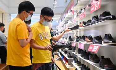 People select shoes in a shopping mall in Beijing on June 15.
