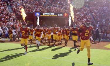 The USC Trojans run onto the field prior to the game against the San Jose State Spartans in August.