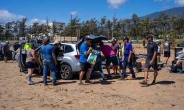 Volunteers unload supplies to be transported to people in need at Kahului Harbor in Maui