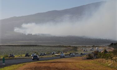 Smoke blows across the slope of Haleakala volcano on Maui