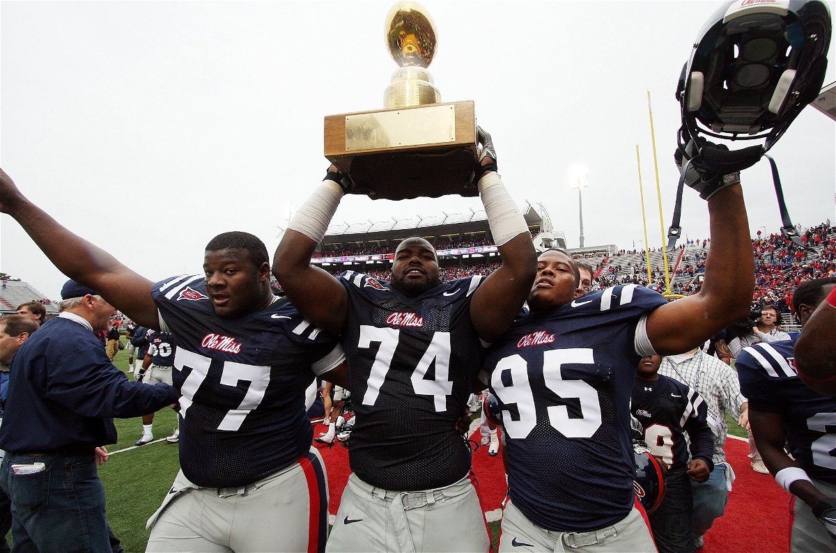Michael Oher hoists the Golden Egg trophy with teammates after Ole Miss beat Mississippi State on November 28, 2008, in Oxford, Mississippi.