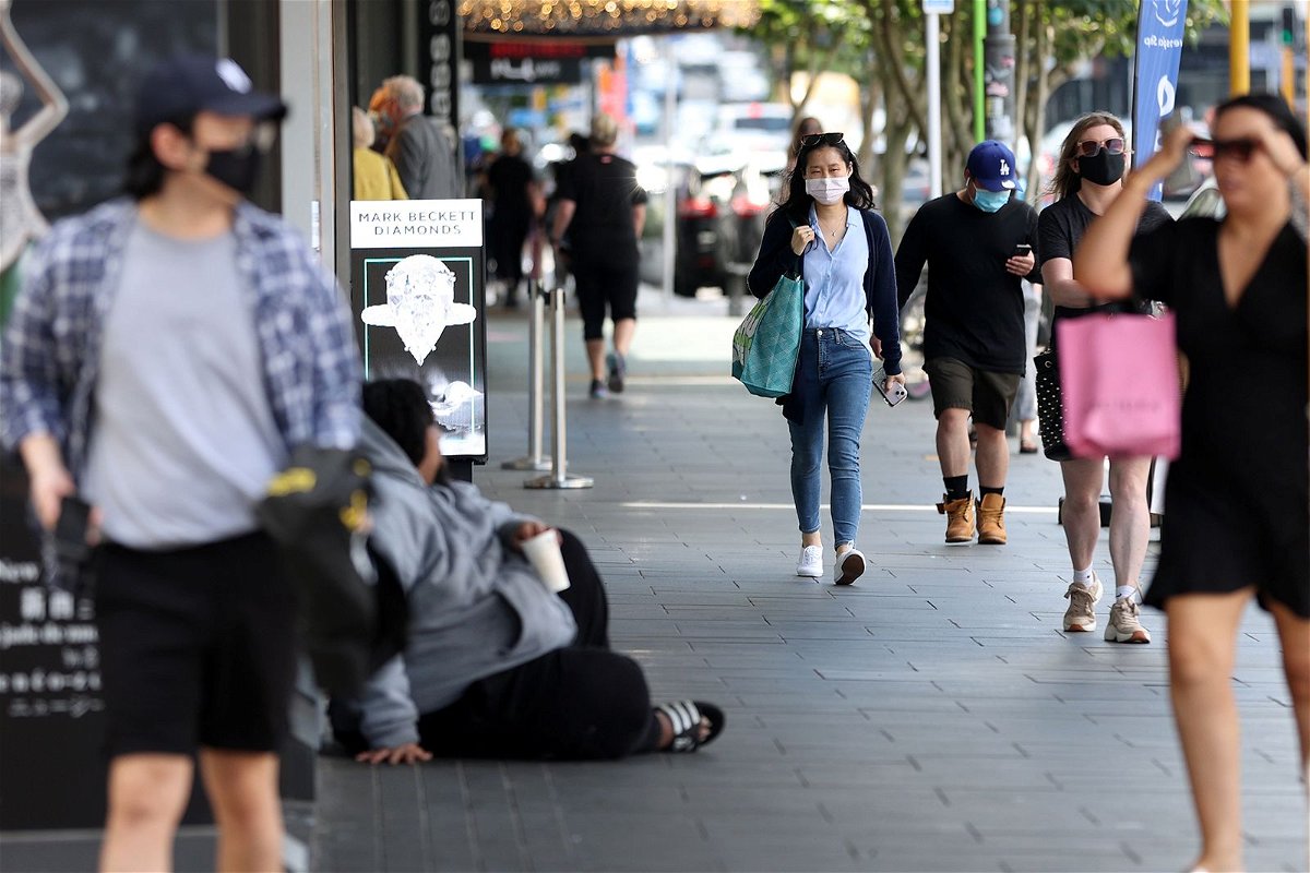 Shoppers walk through a retail district in the wake of Covid-19 lockdown restrictions being eased in Auckland, New Zealand, November 10, 2021.