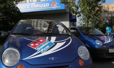 Delivery vehicles stand outside a Domino's Pizza store in Moscow