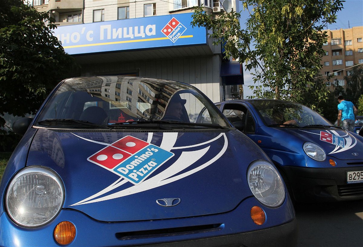 <i>Andrey Rudakov/Bloomberg/Getty Images</i><br/>Delivery vehicles stand outside a Domino's Pizza store in Moscow