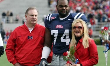 Michael Oher stands with his family during senior ceremonies prior to a game on November 28