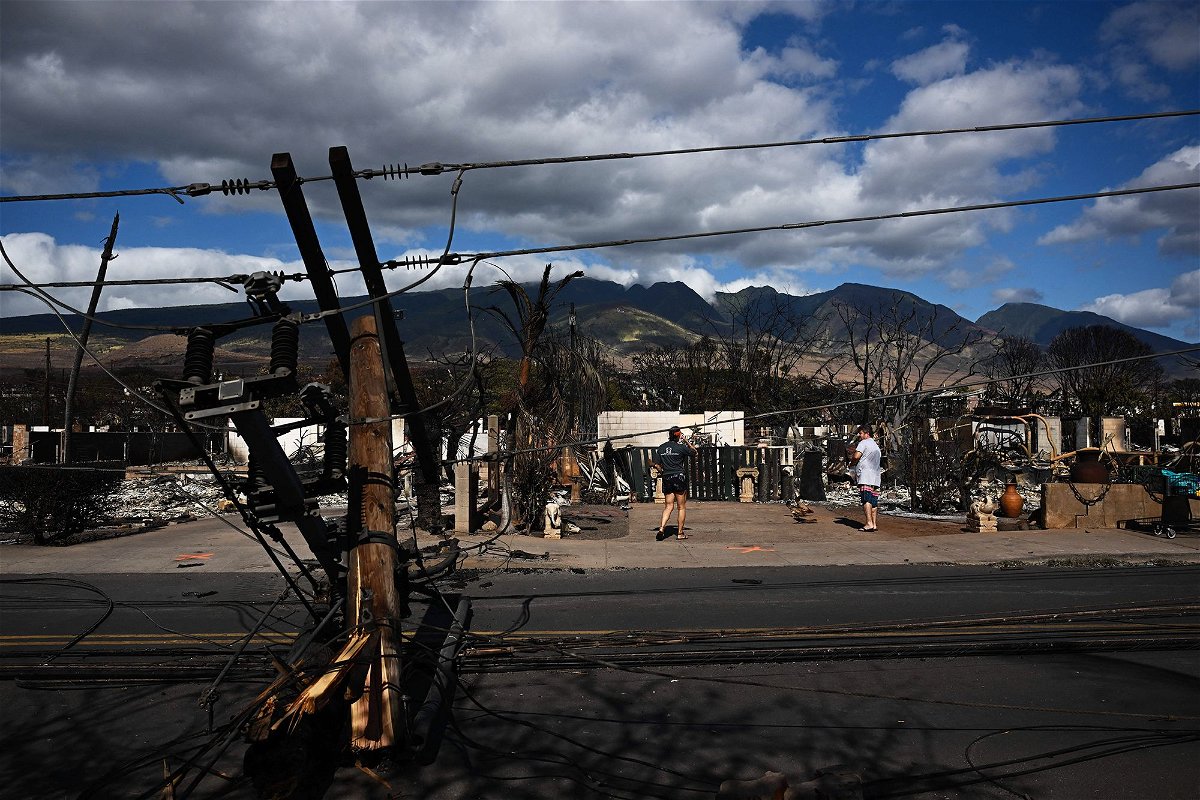 <i>Patrick T. Fallon/AFP/Getty Images</i><br/>Downed power lines block a road outside a burnt home in the aftermath of a wildfire in Lahaina