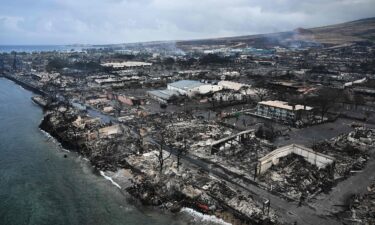 An out-of-control wildfire that began along a major Central Maui highway burns on July 11