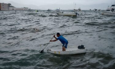 A man rows his boat in Acapulco in the Mexican state of Guerrero on August 16
