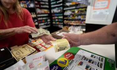 A cashier sells tickets for the Mega Millions lottery in Harahan
