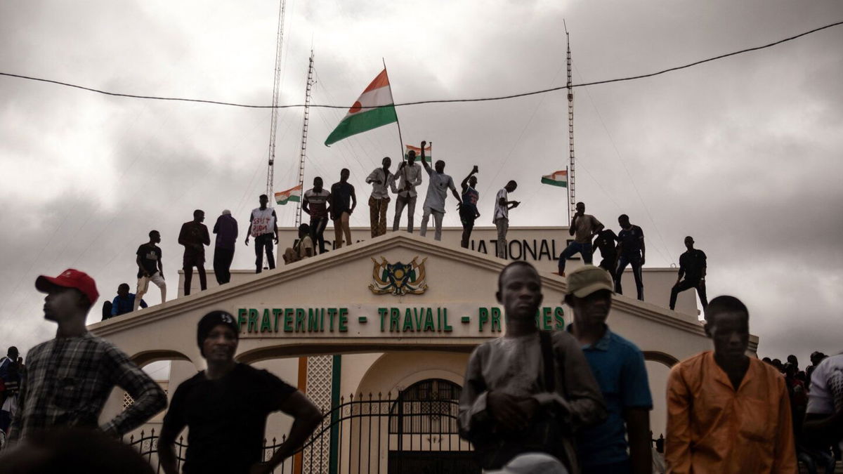 <i>AFP/Getty Images</i><br/>Protesters hold a Niger flag during a demonstration on independence day in Niamey on August 3