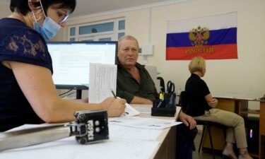 A man fills document to apply for new Russian passport at a centre in Melitopol.