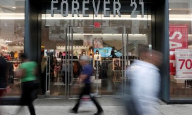 People walk by the clothing retailer Forever 21 in New York City