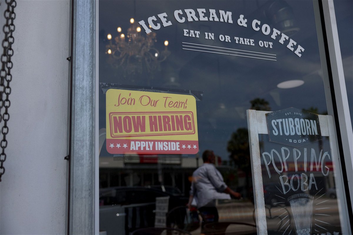 The US labor market is still hot. A 'Now Hiring' sign is posted outside of a restaurant on May 05, in Miami.