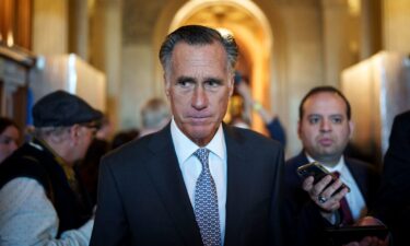 Sen. Mitt Romney leaves the Senate floor at the Capitol on November 16