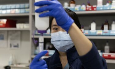 Pharmacist Selena Ko reconstitutes powered antibiotic amoxicillin and measures doses for pediatric patients at Rush University Medical Center in Chicago.