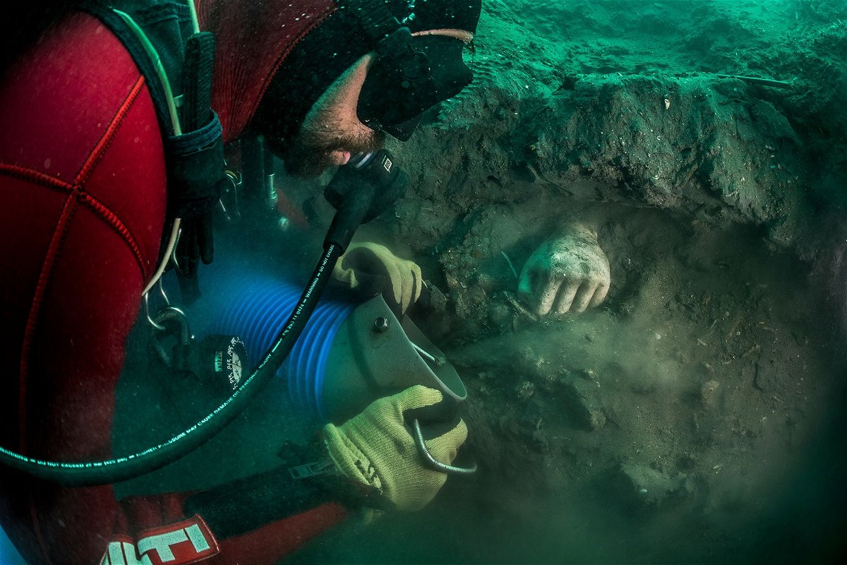 Diving at Thonis-Hercleion to discover ancient treasures is a delicate task. A votive hand  is show emerging from the sediment during an excavation.