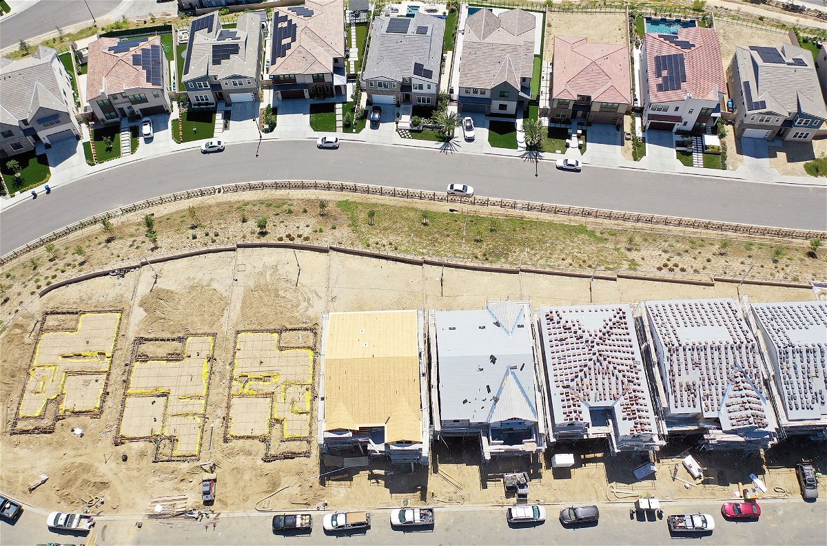 An aerial view of existing homes near new homes under construction (BOTTOM) in the Chatsworth neighborhood on September 8 in Los Angeles, California. According to the National Association of Realtors, the median existing home sale price in the U.S. increased 1.9 percent in July following five straight months of declines, which was the longest stretch of declines in 11 years, amid high-interest rates.