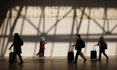 Travelers walk in the international terminal at Los Angeles International Airport (LAX) on August 31 in Los Angeles