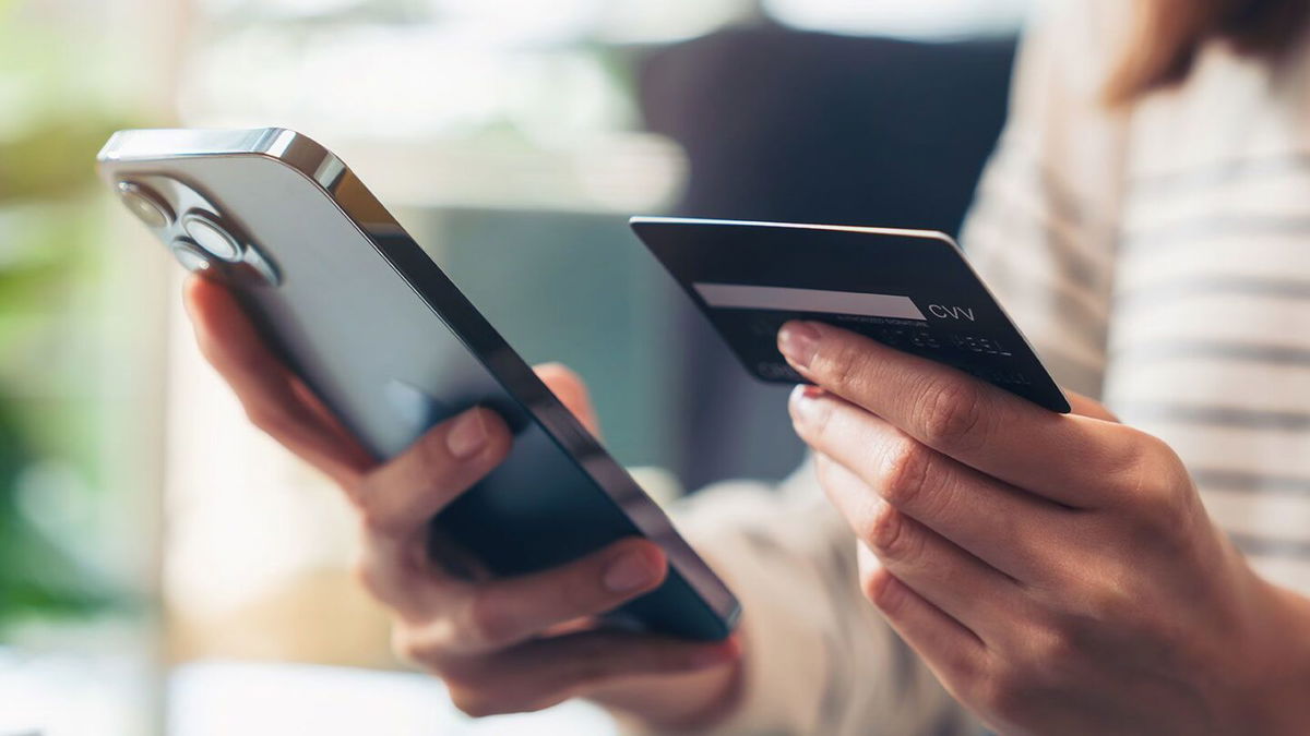 <i>Sitthiphong/iStockphoto/Getty Images/FILE</i><br/>Woman hand holding credit cards and using smartphone for shopping online.