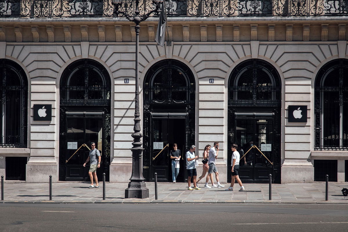 <i>Cyril Marcilhacy/Bloomberg/Getty Images</i><br/>Customers exit an Apple Inc. store in the Opera district in Paris