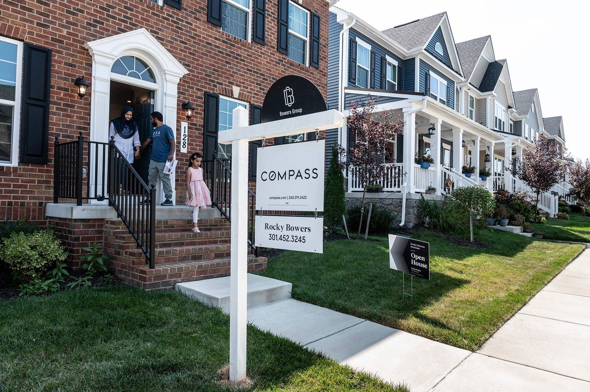 Prospective home buyers leave a property for sale during an Open House in a neighborhood in Clarksburg, Maryland on September 3.