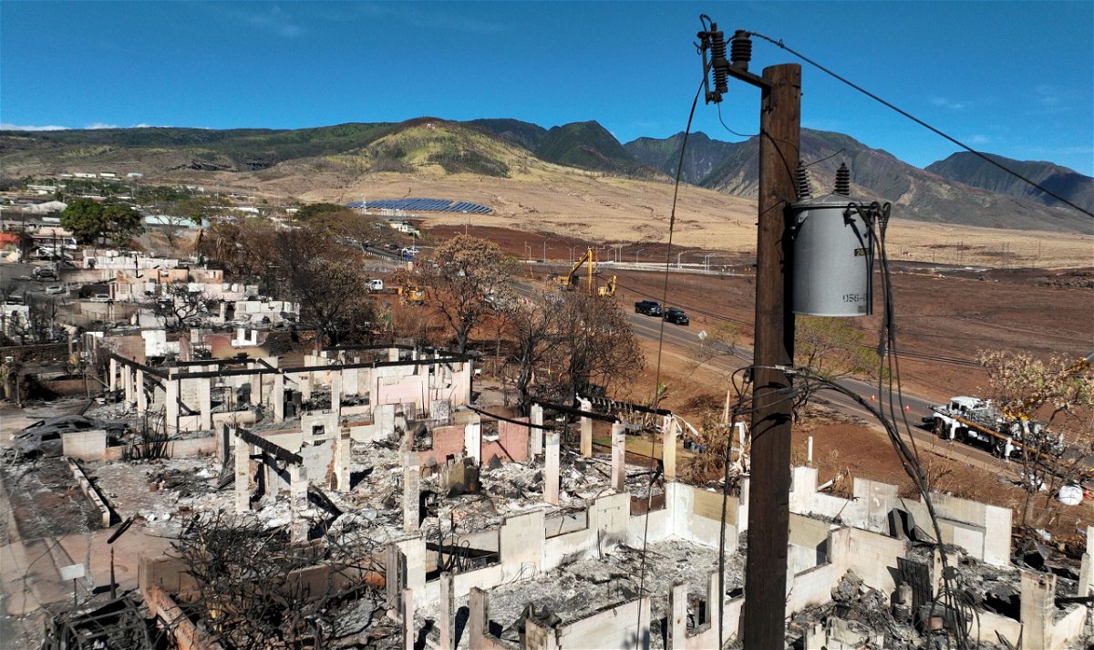 In an aerial view, a power pole stands over burned cars and homes in a neighborhood that was destroyed by a wildfire on August 17 in Lahaina, Hawaii.