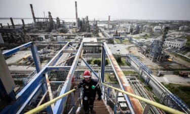 A Total Energies employee walks in the Donges oil refinery in Donges