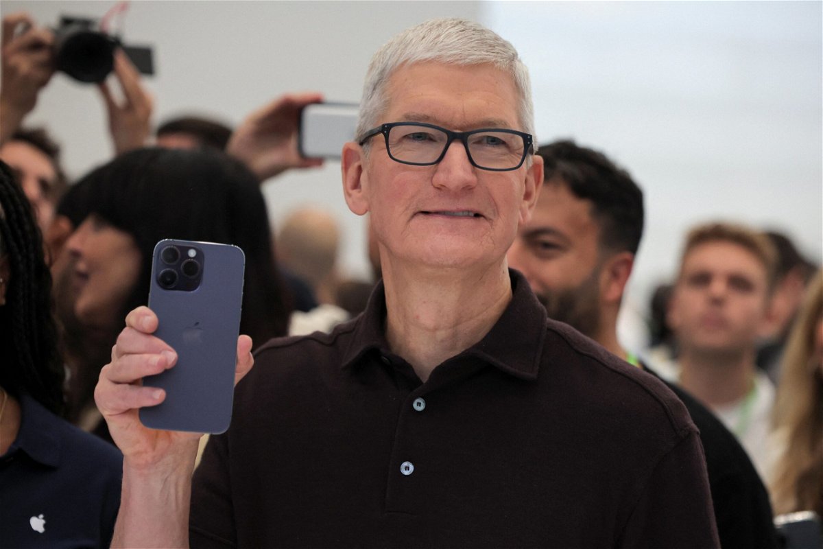 Apple CEO Tim Cook holds the new iPhone 14 at an Apple event at their headquarters in Cupertino, California, U.S. September 7, 2022. Apple is expected to debut its iPhone 15 lineup on September 12 at the company’s annual September keynote event.
