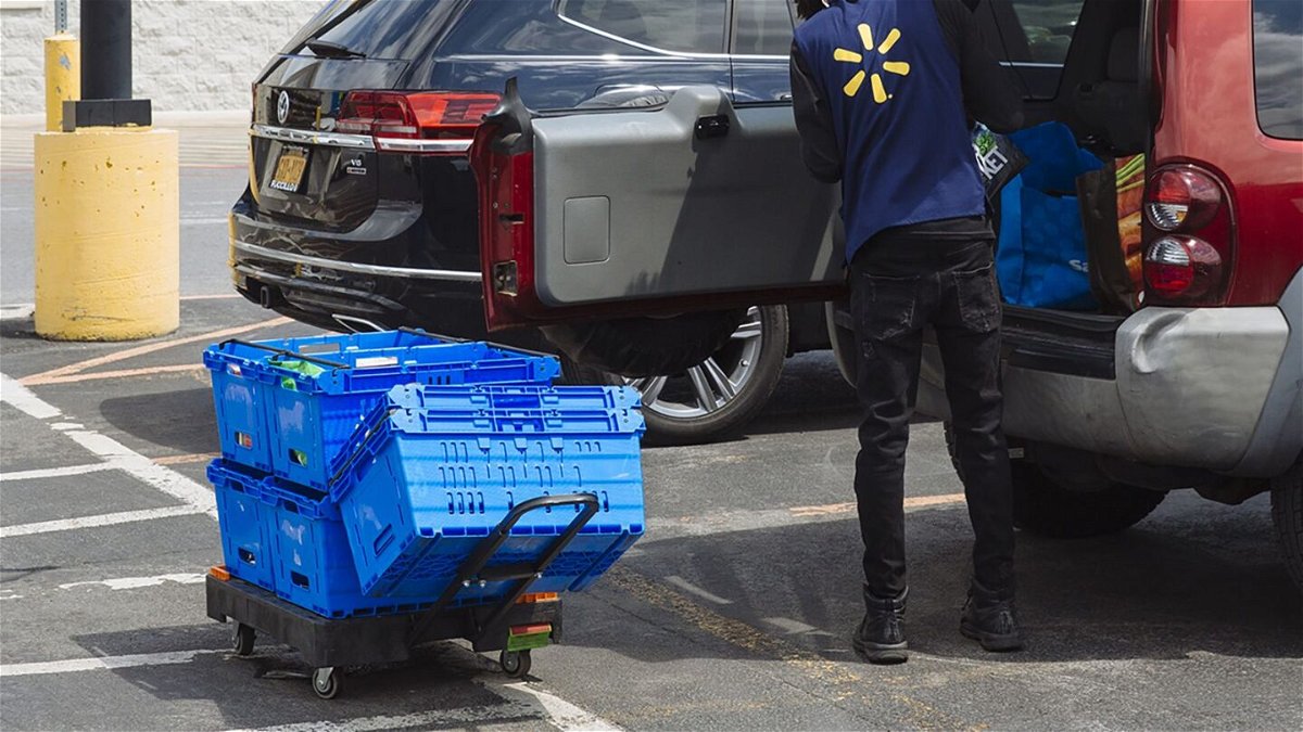 <i>Angus Mordant/Bloomberg/Getty Images</i><br/>A worker delivers groceries to a customer's vehicle outside a Walmart Inc. store in Amsterdam