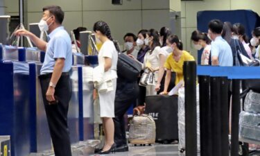 Passengers prepare to board the first Air Koryo flight from Beijing to Pyongyang