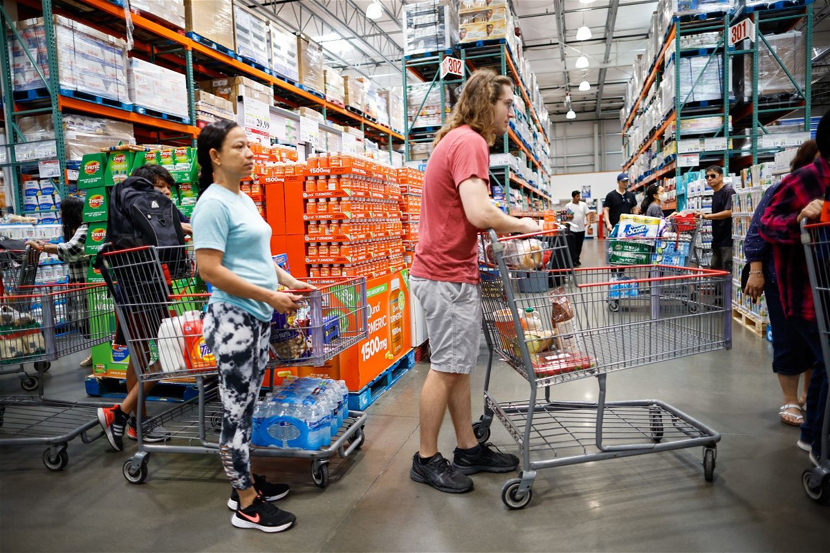 Customers wait in line to check out purchases at Costco store on June 28 in Teterboro, New Jersey.
