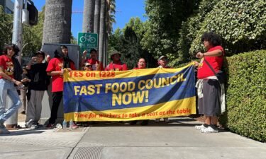 Fast food workers and union activists demonstrate outside the California State Capitol in support of legislation to increase fast-food worker wages to $20 an hour
